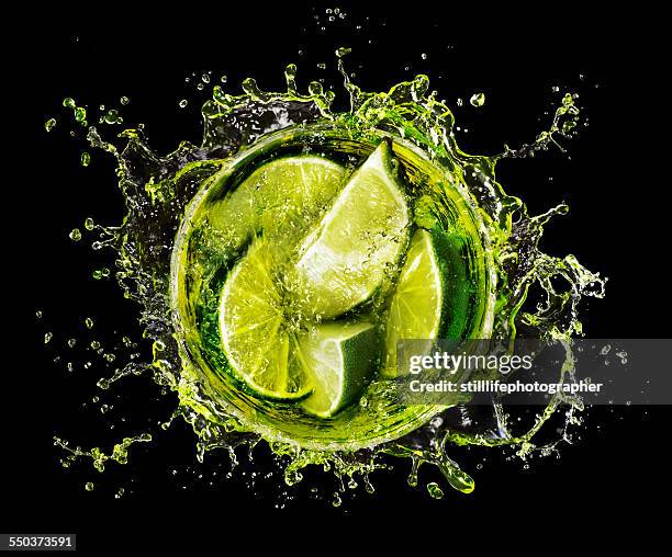 lime splash into cocktail glass - alcohol top view stock pictures, royalty-free photos & images