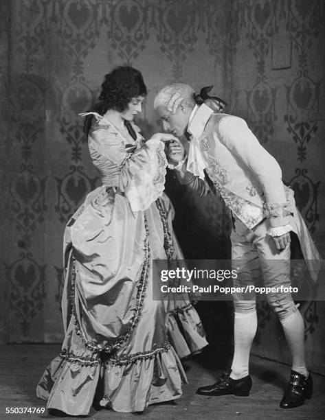 Portrait of actors Leslie Howard as Peter Standish and Valerie Taylor as Kate Pettigrew, as they appear in the play 'Berkeley Square' at the Lyric...