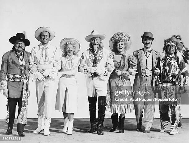 Stars of the American musical film 'Annie Get Your Gun' pictured together in costume in 1950; Edward Arnold, Howard Keel, Betty Hutton, James Calkin,...