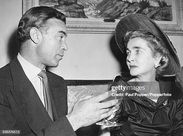 American heiress to the Woolworth estate, Barbara Hutton makes a toast with her new husband Porfirio Rubirosa following their wedding in New York,...