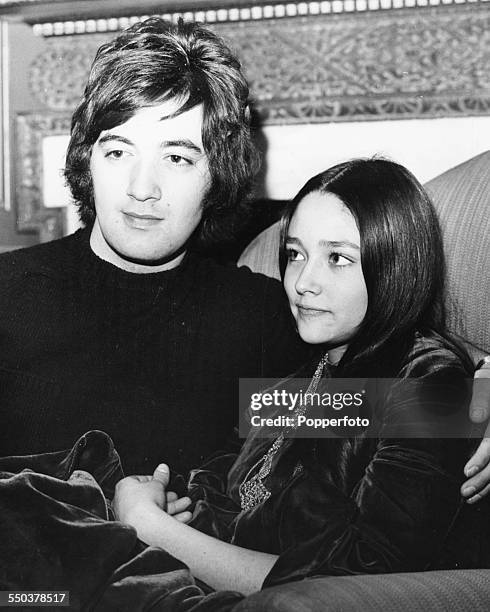 English singer Paul Ryan pictured with actress Olivia Hussey sitting together on a sofa, February 5th 1969.