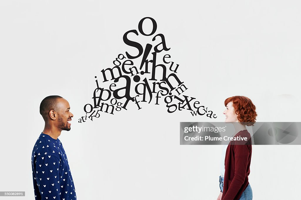 Man and woman with illustrated jumble of letters
