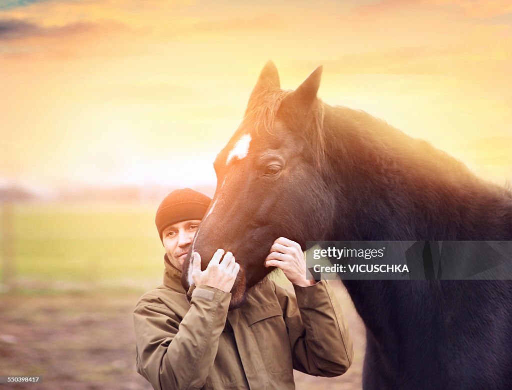 Man hugs  horse head.