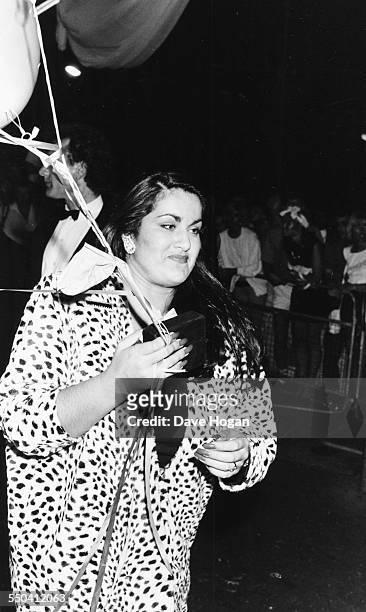 Melanie Panayiotou, sister of singer George Michael, holding balloons as she attends the 'Wham!' farewell party, London, July 8th 1986.