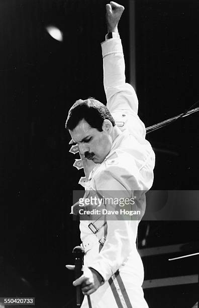 Singer Freddie Mercury, his band 'Queen', performing on stage at Wembley Stadium, London, July 15th 1986.