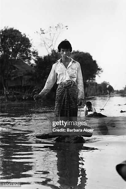 Man and a boy riding water buffalo through Inle Lake, Taunggyi District, Burma , 20th February 1988.