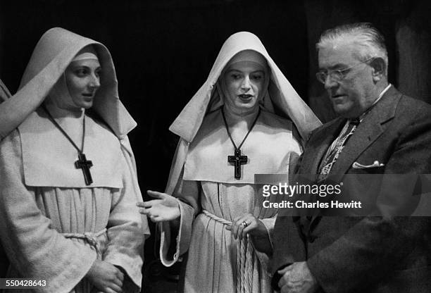 British actresses Kathleen Byron and Deborah Kerr with American film censor, Joseph Breen , on the set of 'Black Narcissus', directed by Michael...