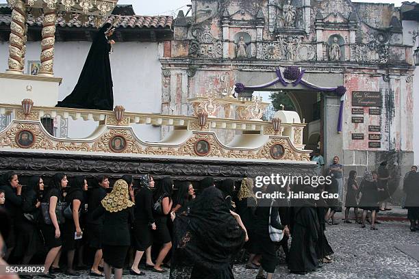 Women in black dresses in Holy Saturday funeral procession dedicated to Virgin Mary