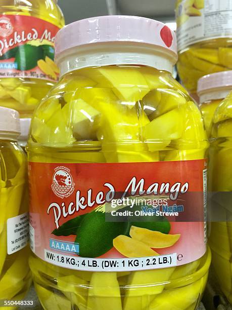 Pickled mango in a large glass jar
