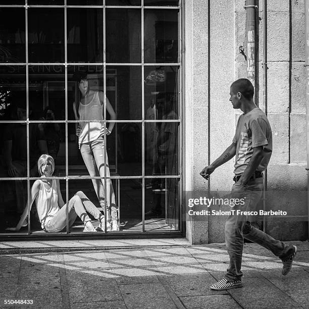 Man walking by a shop window