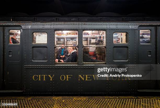 People looking out of the window on the NYC "Nostalgia" vintage subway train. New York City, USA