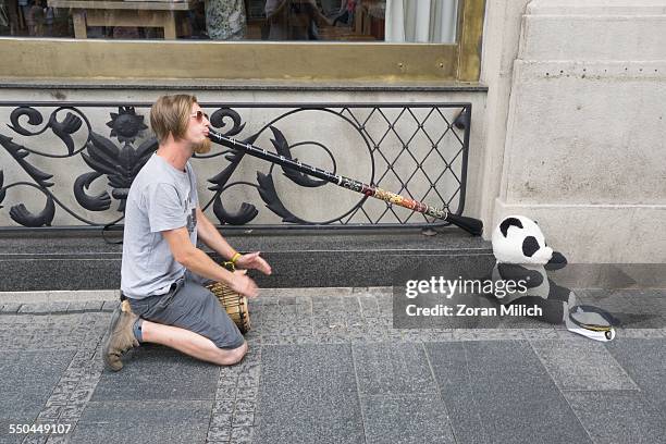 Man plays a didgeridoo on the street of Belgrade's Knez Mihailova Street in Belgrade, Republic of Serbia.