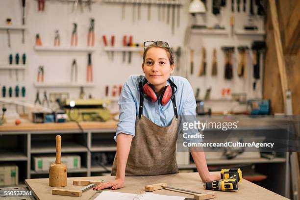 young carpenter in wood workshop - wood worker posing ストックフォトと画像