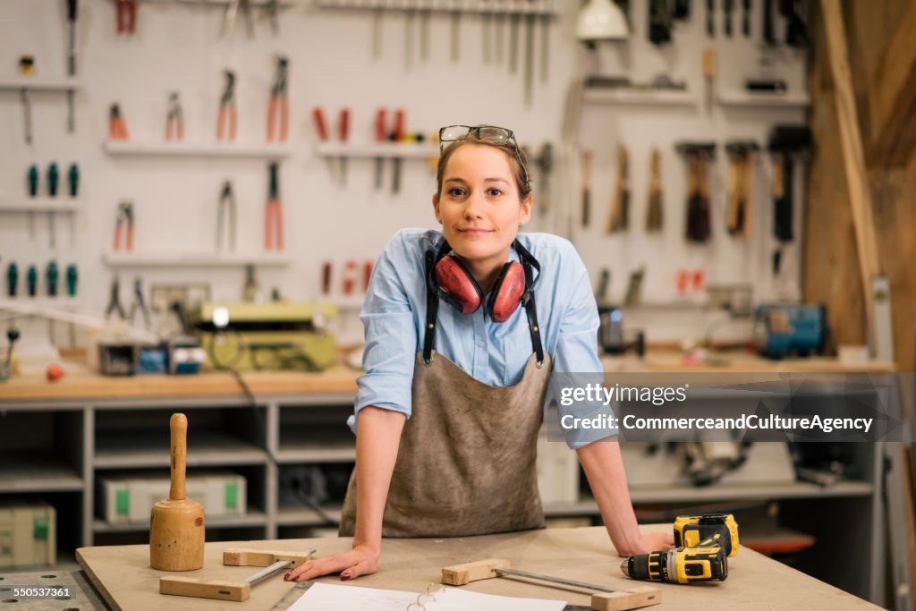 Young carpenter in wood workshop