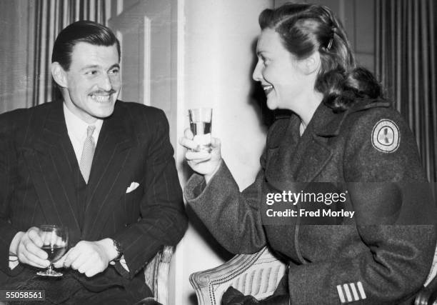 British actress Madeleine Carroll with film executive John Ward at a Savoy Hotel cocktail party to mark her return to Britain after wartime service...