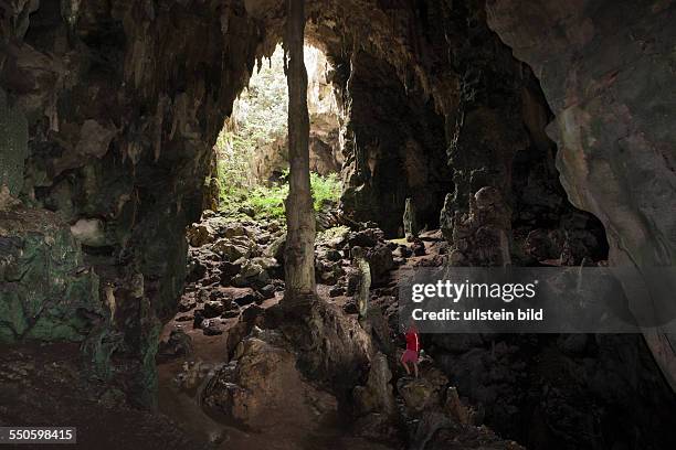 Tourist inside Kotilola Cave, Baliem Valley, West Papua, Indonesia