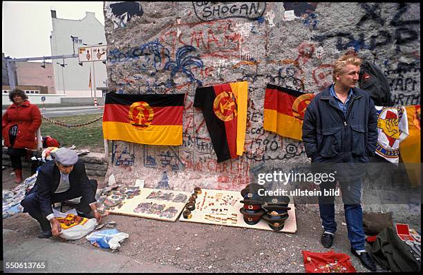 Sale of broken out pieces of the Berlin Wall, East Germany flags, militaria, military decorations and badges with communist symbols at the allied...
