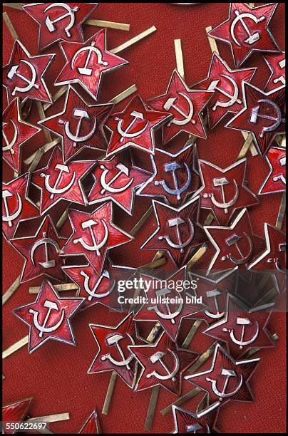 Sale of broken out pieces of the Berlin Wall, militaria, military decorations and badges with communist symbols at the allied border crossing point...