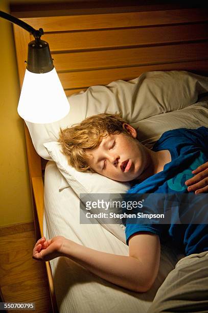 9-year-old boy sleeping - child asleep in bedroom at night stock pictures, royalty-free photos & images
