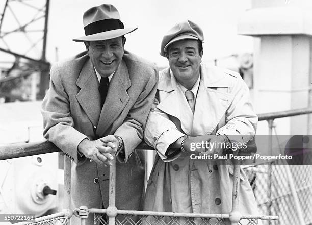 Bud Abbott and Lou Costello of American comedy double act Abbott and Costello, pictured together smiling on the deck of a ship as they arrive from...