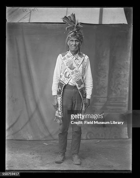 Portrait of Native American Chippewa or Ojibwa man Nah-ee-Gance Chippewa from Leech Lake Minnesota, with beaded bags and wearing moccasins and...