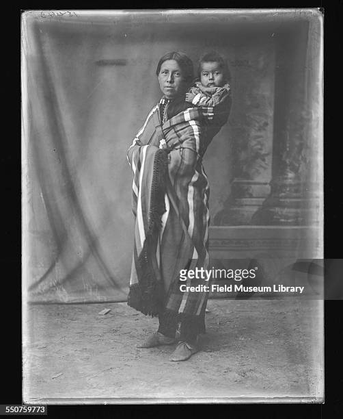 Unidentified Native American woman with a baby in a papoose on her back at the Louisiana Purchase Exposition, St Louis, Missouri, June 6, 1904.