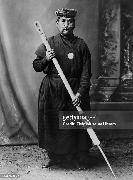 Portrait of First Nations Nuu-chah-nulth man Chief Atlui standing with a carved and painted post at the Louisiana Purchase Exposition, St Louis,...