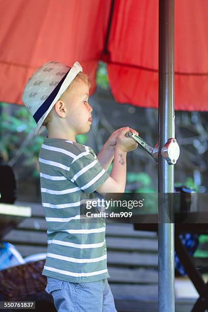 working hard - boy in hard hat photos et images de collection