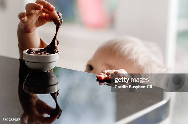 helping myself to the chocolate - sticky fotografías e imágenes de stock