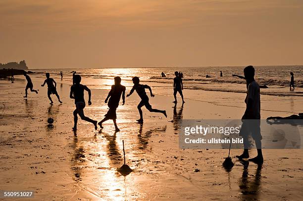 Der Strand beim Sonnenuntergang, Kinder beim Fussball spielen