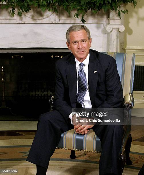 President George W. Bush poses for photographers in the Oval Office at the White House September 6, 2005 in Washington, DC. President Bush spoke...