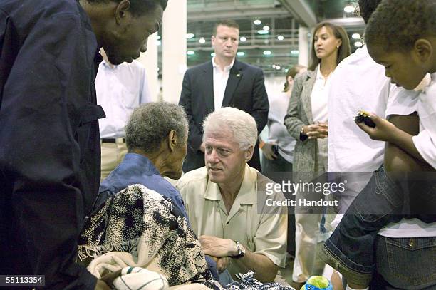 In this handout from the Federal Emergency Managment Agency , former U.S. President Bill Clinton visit Hurricane Katrina evacuees at a Red Cross...