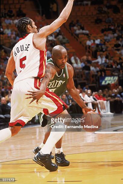 Point guard Kenny Anderson of the Boston Celtics drives past guard Eddie House of the Miami Heat during the NBA game at American Airlines Arena in...