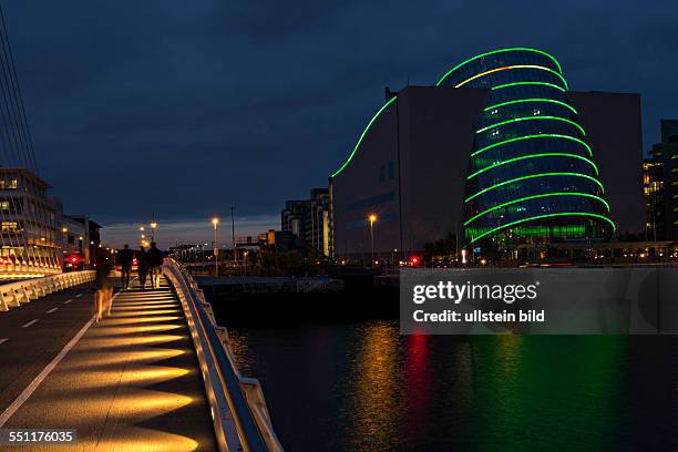 Dublin Convention center illuminated at night with the Samuel Beckett Bridge , Dublin, Republic of Ireland, Europe.