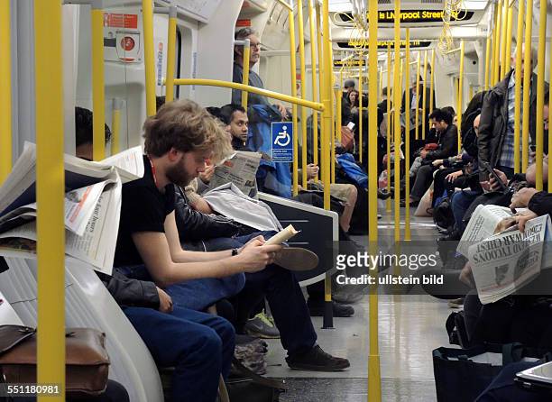 England, London, London City, , Innenansicht Londoner U- Bahn, Fahrgäste lesen Evening Standard, das Blatt wird an Bahnhöfen und U-Bahn-Stationen...