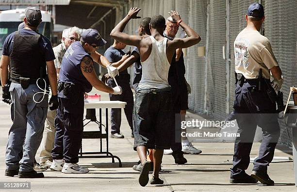 Jailed inmate walks in a temporary prison inside a Greyhound bus terminal September 6, 2005 in New Orleans, Louisiana. About 150 inmates who were...