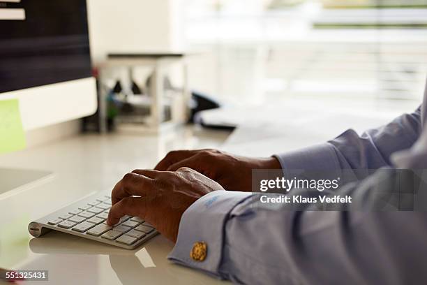 close-up of businessman typing on keyboard - gemelli da polso foto e immagini stock