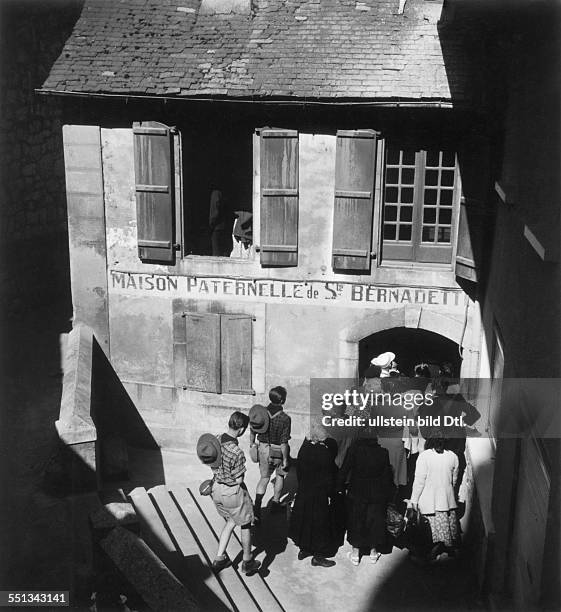 The birthplace of the saint Bernadette Soubirous with a lot of pilgrims at the entrance Vintage property of ullstein bild