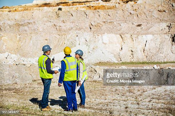 construction team discussing at quarry - miners stock-fotos und bilder