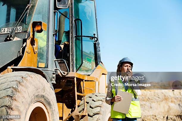 architect using walkie-talkie at quarry - walkie talkie stock pictures, royalty-free photos & images