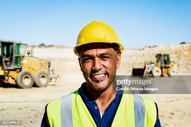 happy quarry worker at construction site - miner stockfoto's en -beelden