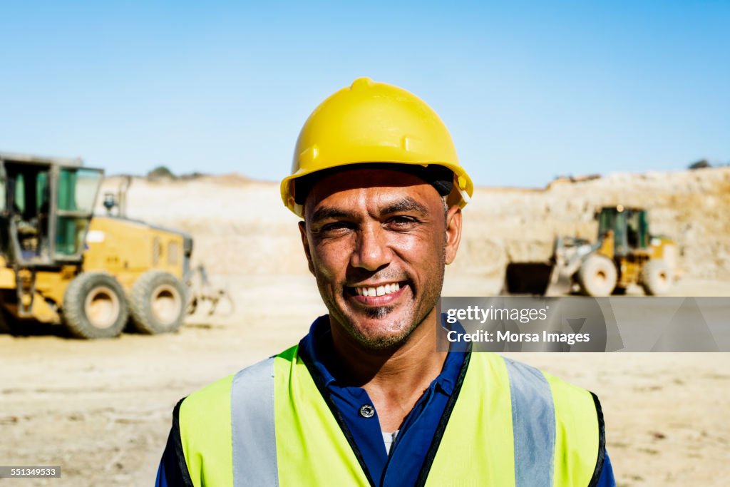 Happy quarry worker at construction site