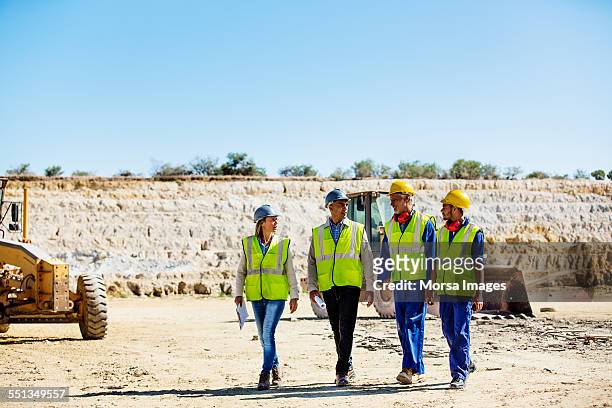 construction team discussing at quarry - four people stock pictures, royalty-free photos & images