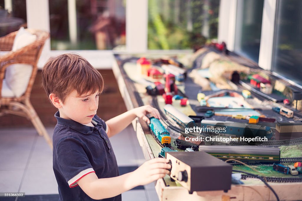 Boy playing with train set