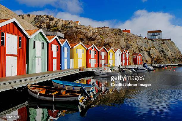 colorful fishing huts at water - schweden stock-fotos und bilder