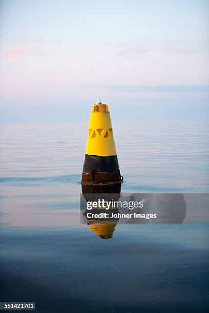 yellow cone at sea - buoy stock pictures, royalty-free photos & images