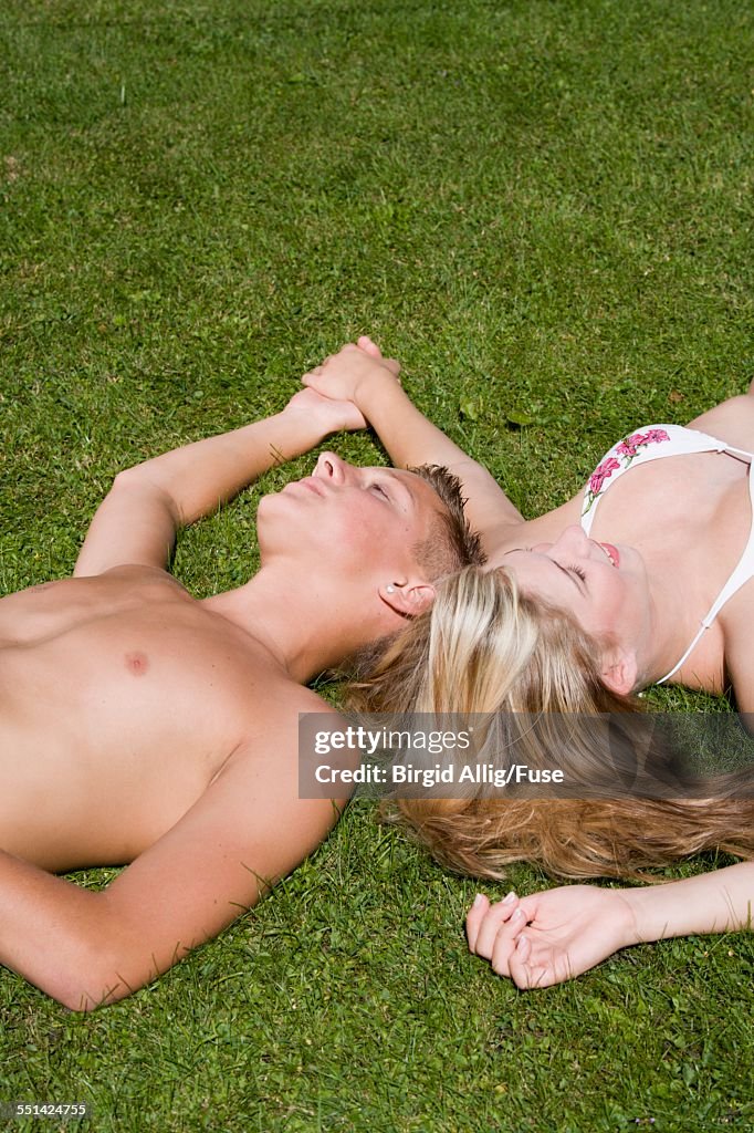 Teenage Couple Lying on Grass