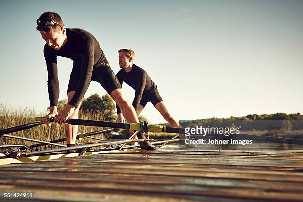 young men at canoe - rowboat stockfoto's en -beelden