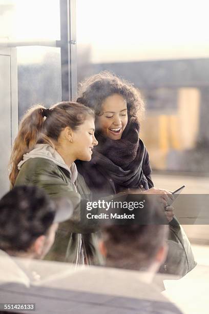 happy female university students using digital tablet on subway station - stockholm metro stock pictures, royalty-free photos & images