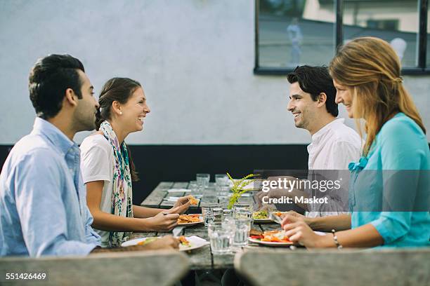 happy couples at outdoor cafe having lunch - four people foto e immagini stock